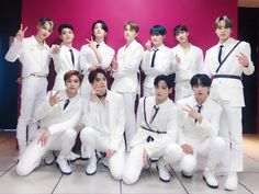 This contains an image of the boyz in white suits posing for a photo with their fingers up