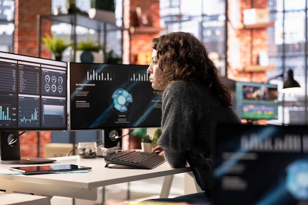 Young woman watching business conference infographics on computer