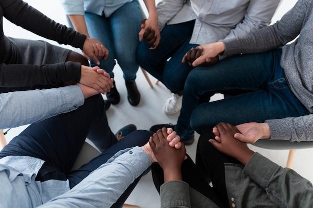 Top view patients standing in circle and holding hands