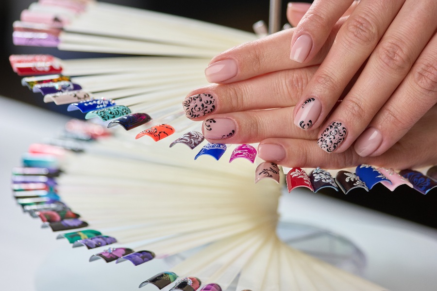 Gothic lace patterns bring a dark, elegant twist to French nail tip design.