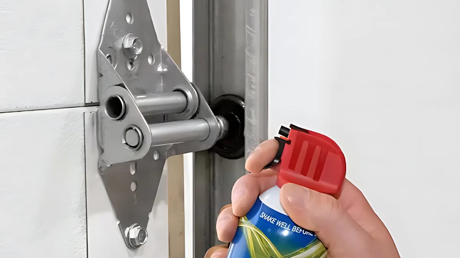 Applying lubricant to fix squeaky garage door rollers and hinges