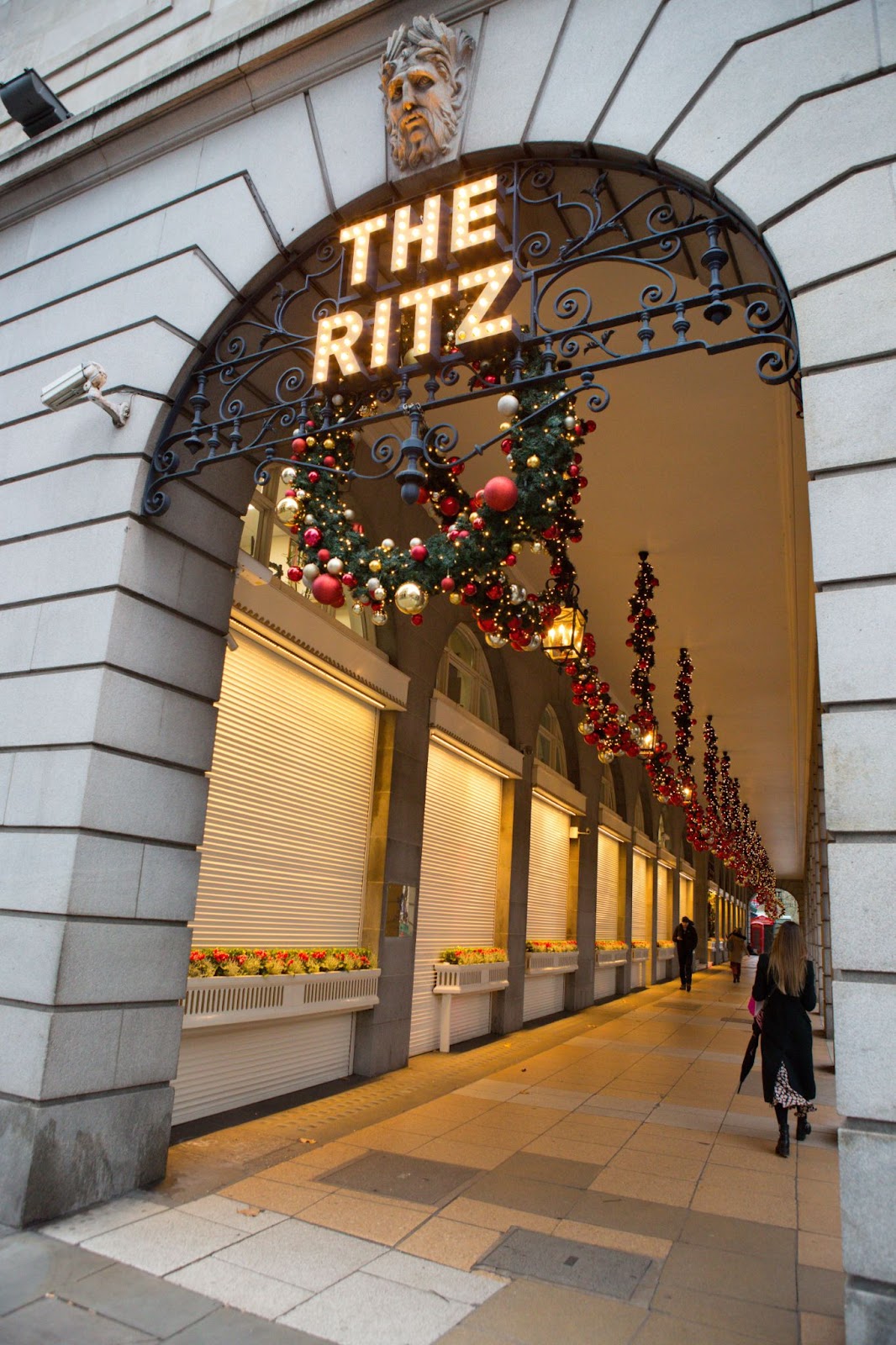 Elegant afternoon tea setup at The Ritz London, with festive decor, champagne glasses, and holiday-themed treats