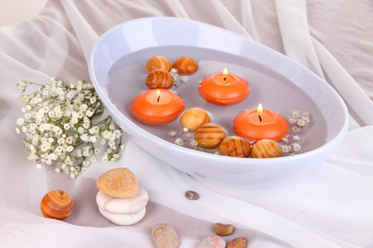 Elegant floating candle setup with glass bowls and rose petals, ideal for romantic wedding table decorations.

