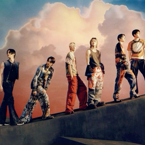 This  contain an image of RIIZE | SM Entertainment standing on top of a cement wall with clouds in the background