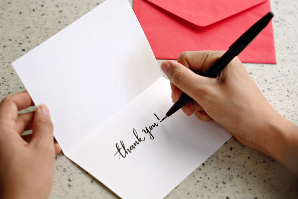 Woman writing a thank you message