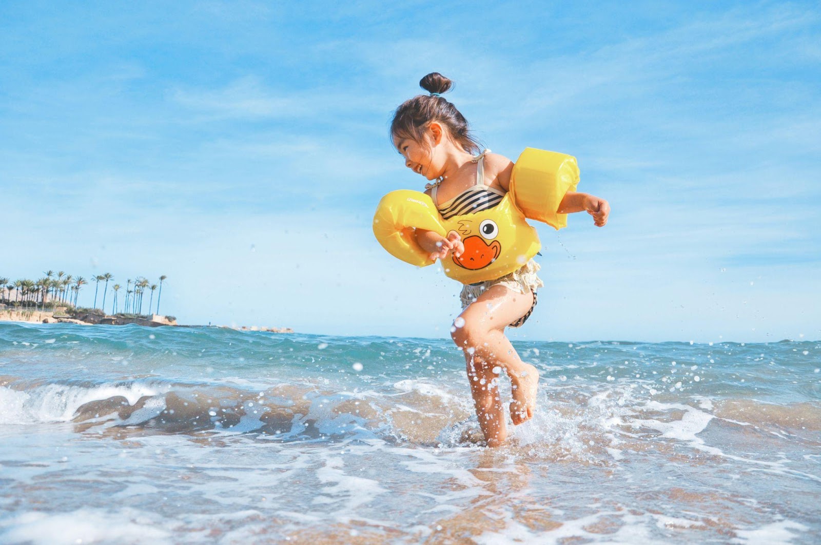 little girl playing in the ocean