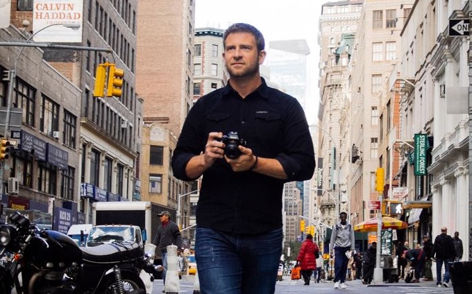 Chase Jarvis walking through a city with camera in hand, looking for subjects to shoot.