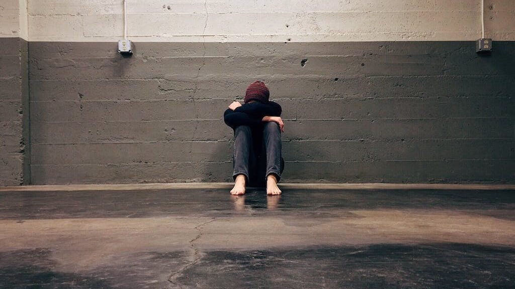 Person Leaning on Wall