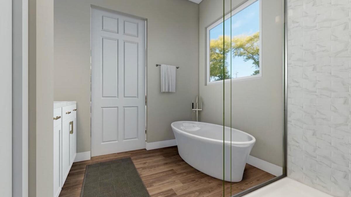 Primary bathroom with white vanity and a freestanding tub placed under the picture window.