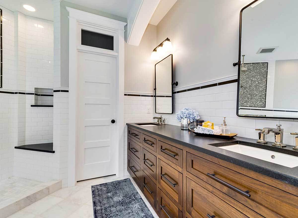 The primary bathroom is equipped with a walk-in shower, a toilet room, and a dual sink vanity.
