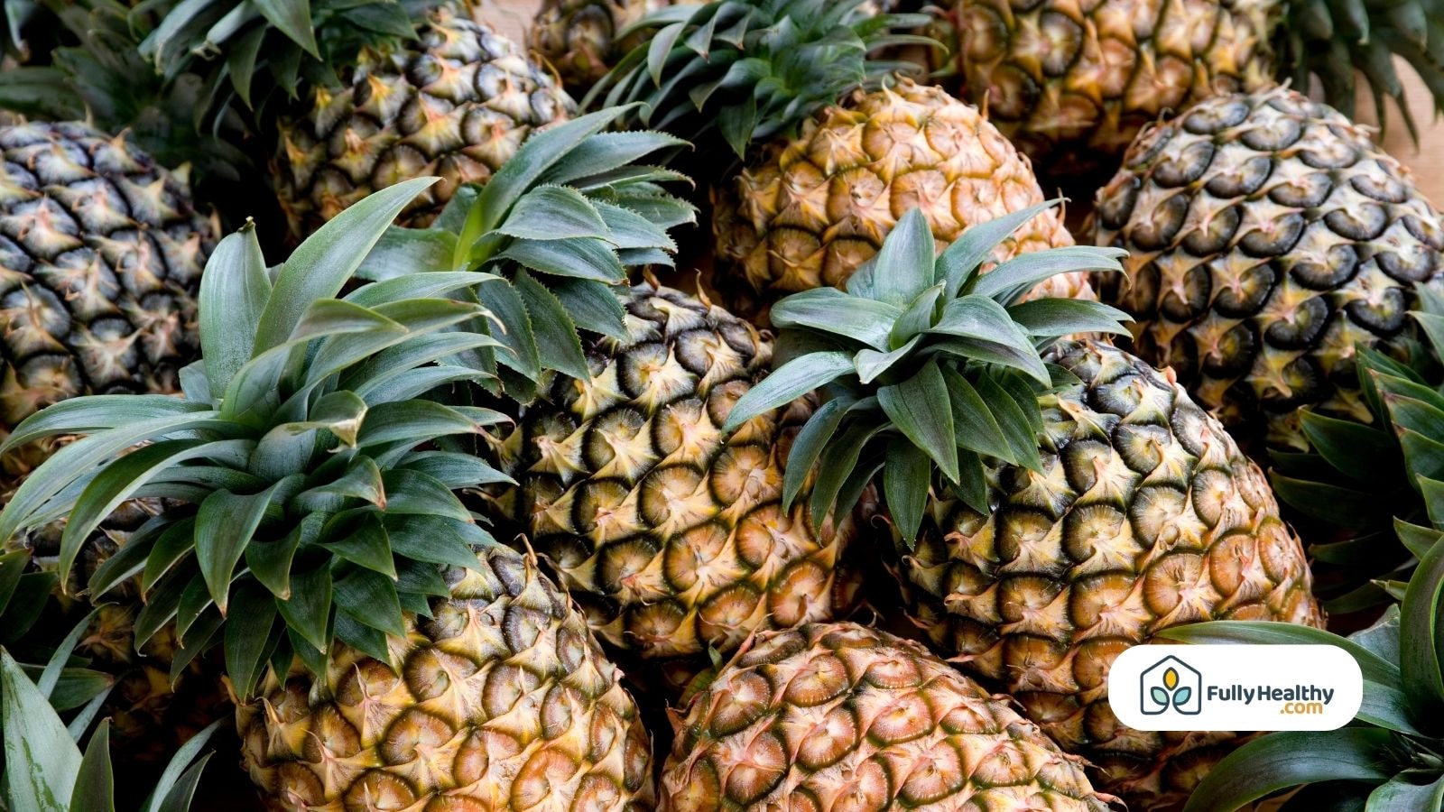 Close-up of pineapples with green leaves and textured outer skin
