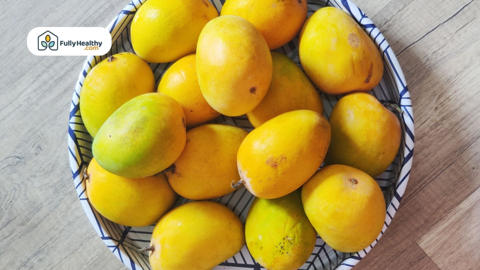 Sliced fresh and dried mangoes with green leaves arranged aesthetically