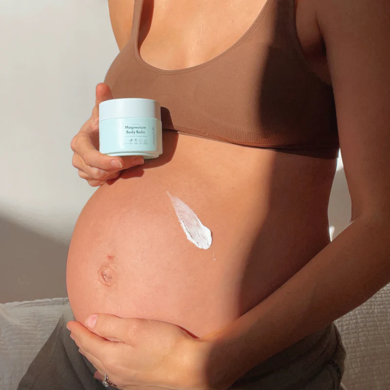 pregnant woman using magnesium body balm