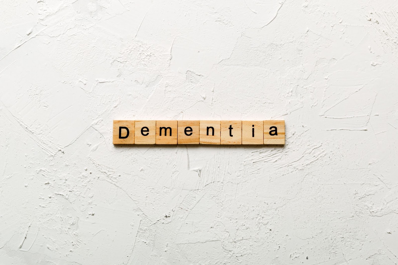 scrabble letters that spell 'dementia' on a white back ground.