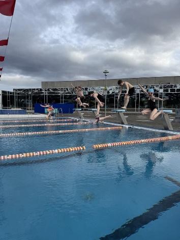 A group of people jumping into a pool
AI-generated content may be incorrect.