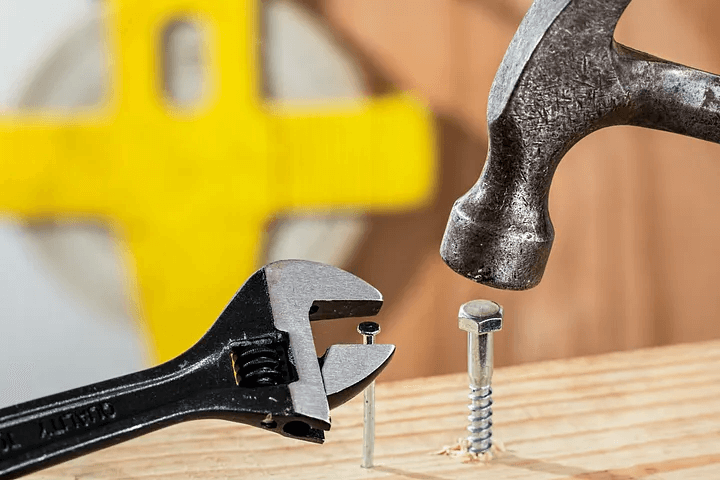 A hammer striking a screw nail, illustrating the misuse of tools which could be a garden tool mistake you are probably making.
