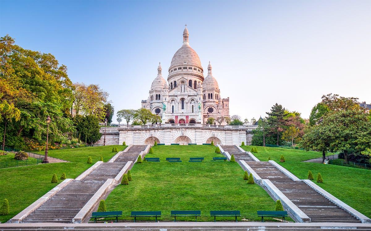 A building with a dome and a green lawnDescription automatically generated