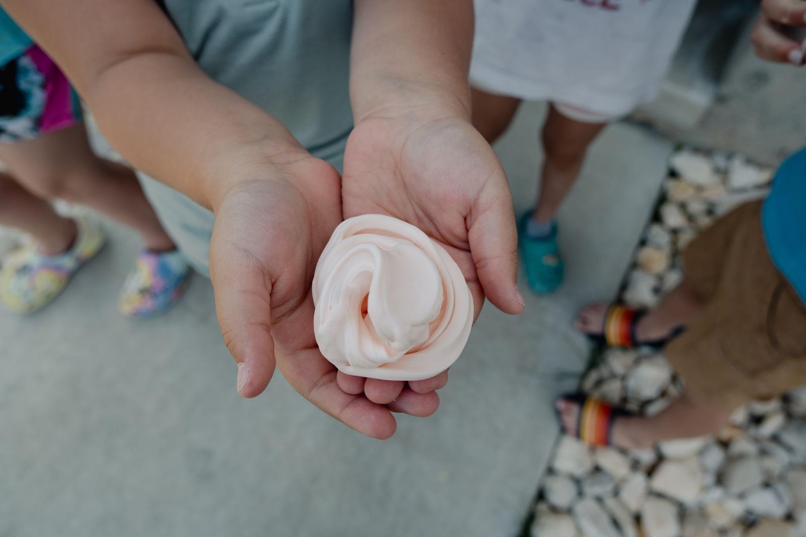 child holding slime or putty in hands