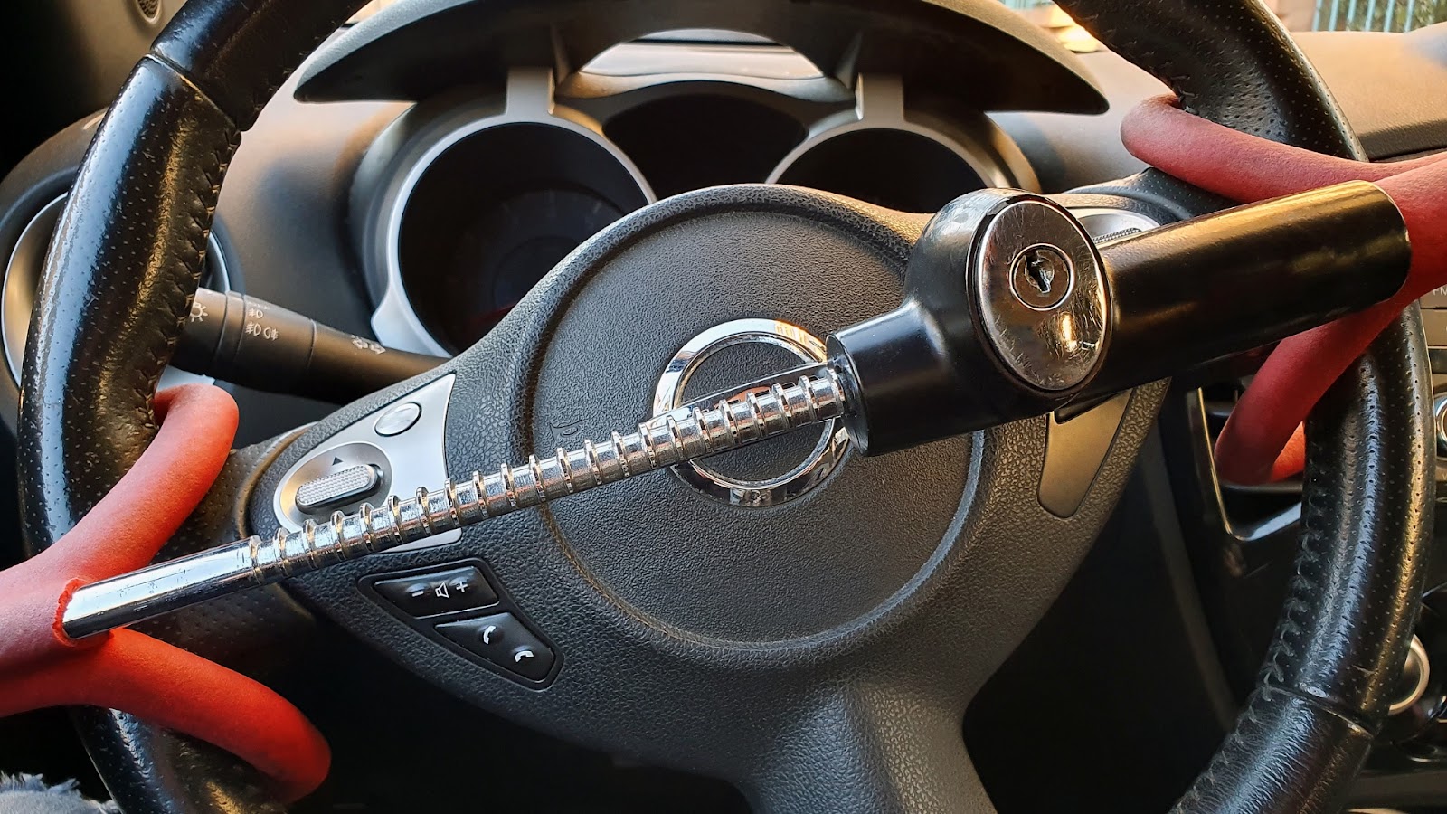 A steering wheel lock is installed to enhance car security.