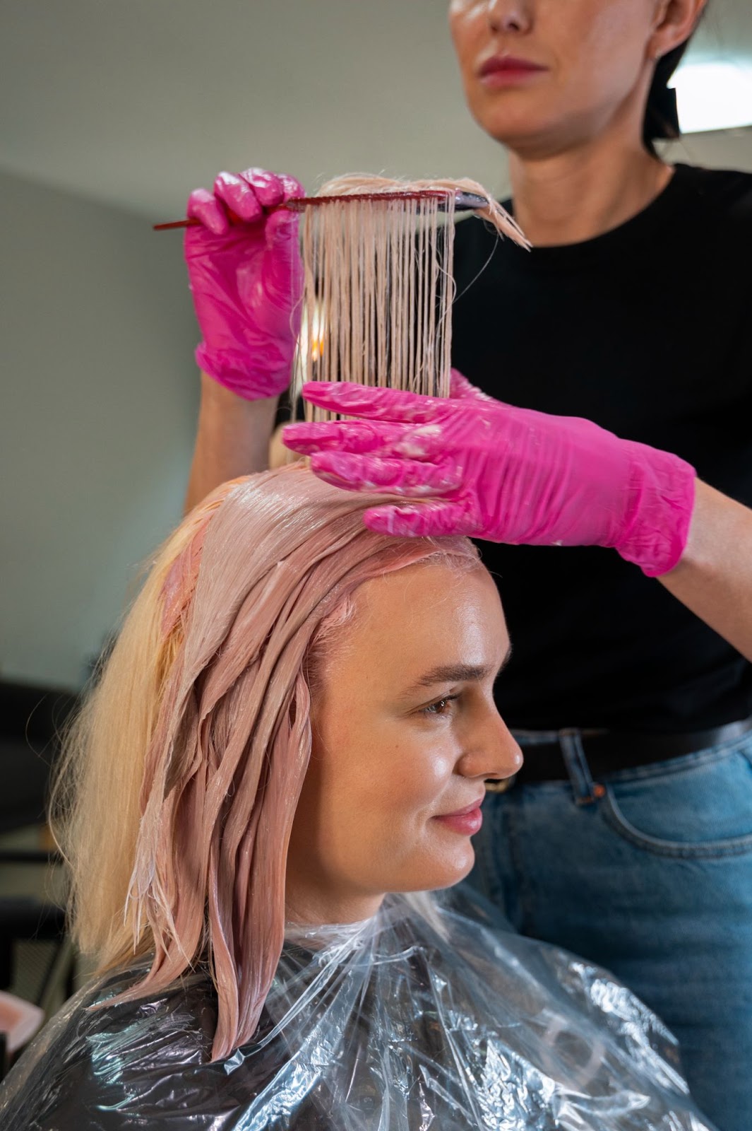 A woman getting hair extensions colored