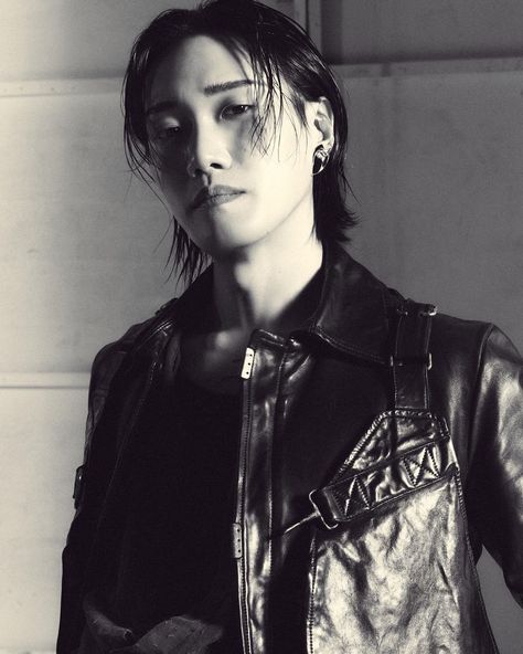 This contain DPR Artic black and white photograph of a woman wearing a leather jacket