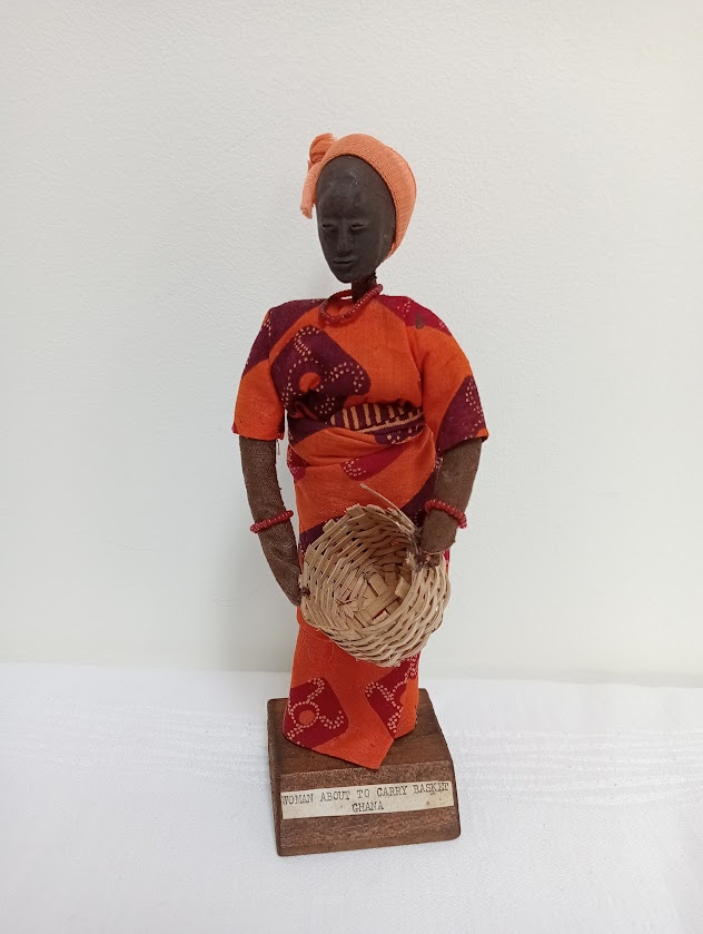 A doll from Ghana depicting a woman holding a basket