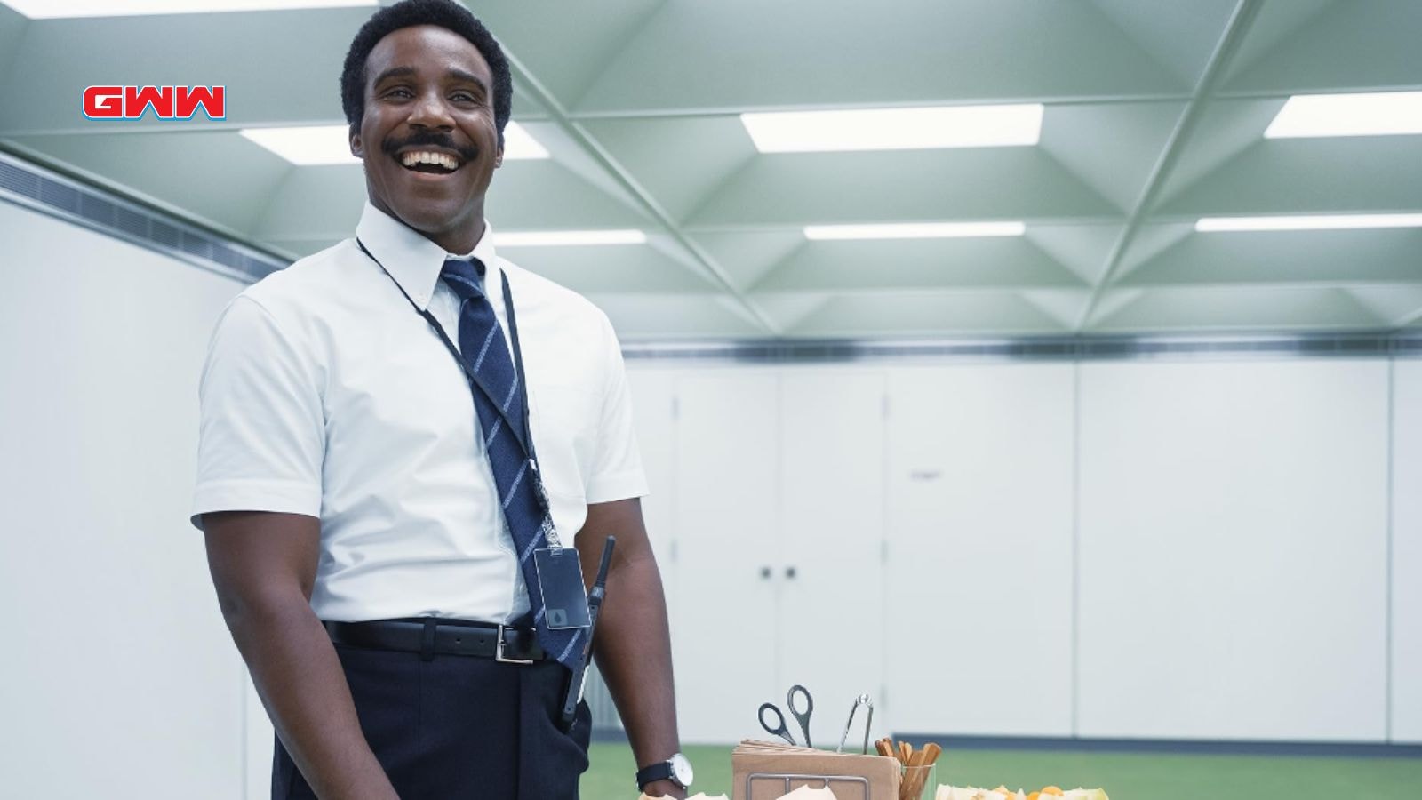 Seth smiles in a white shirt and tie in a sterile room.