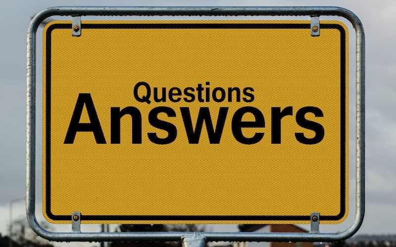 A yellow signage with text "Questions Answers"