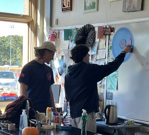 image of students teaching visitors about cells