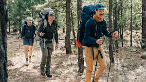 Campers dressed smart and readily prepared for rainy weather as one of the top survival hacks for rainy weather camping