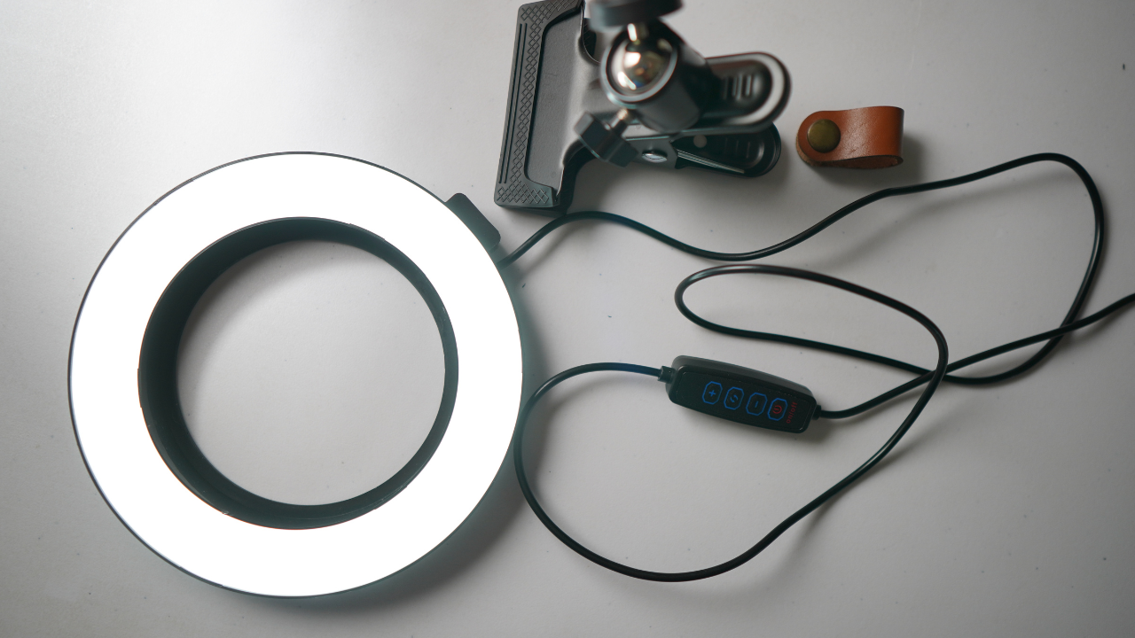 A picture of a clip-on ring light laying flat on a white table.