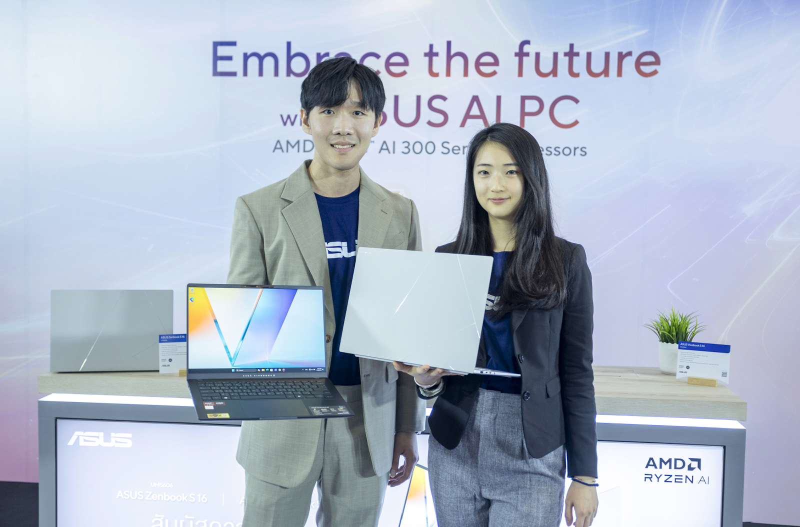 A person and person holding a computer and a computer

Description automatically generated