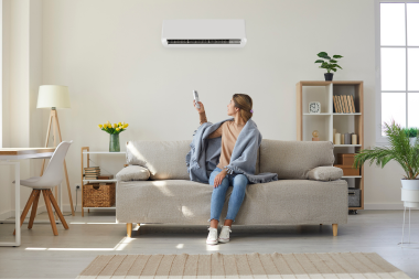 how a home remodeling project can positively impact your family homeowner adjusting hvac system in living room custom built michigan