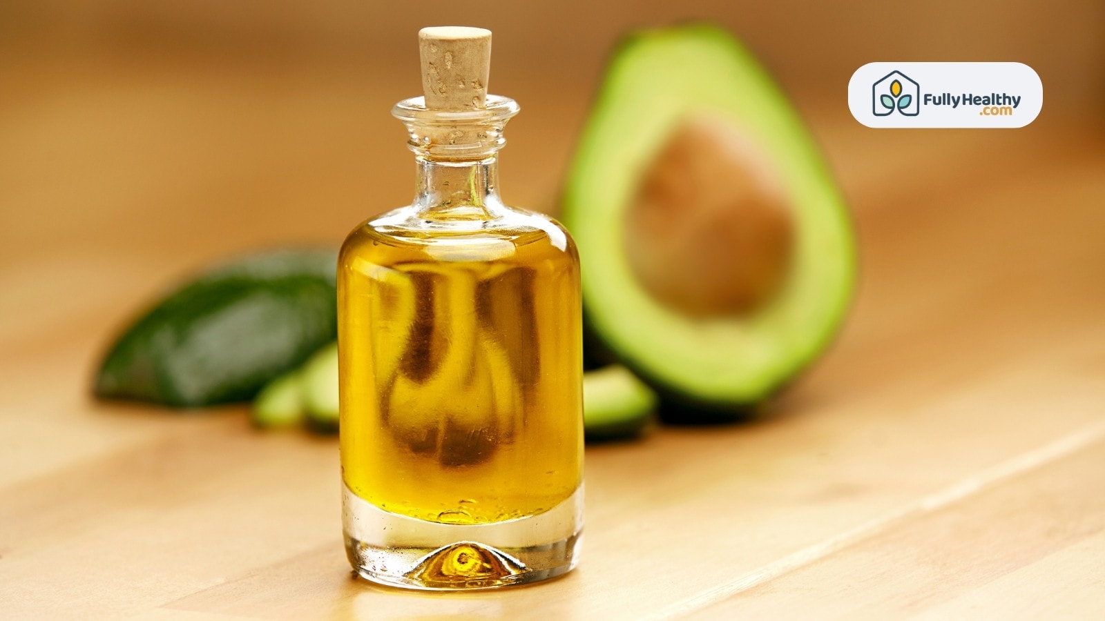 Small glass bottle of avocado oil with blurred avocado background