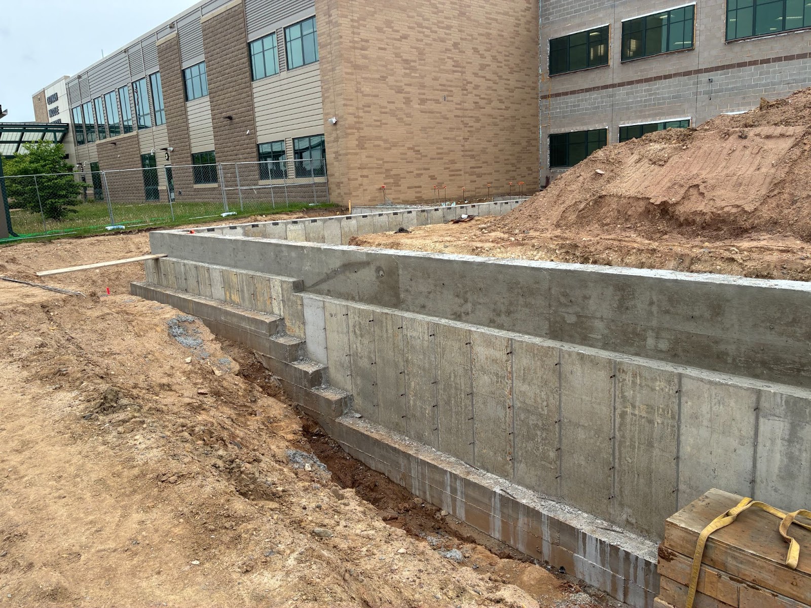 A construction site with a building and a road
