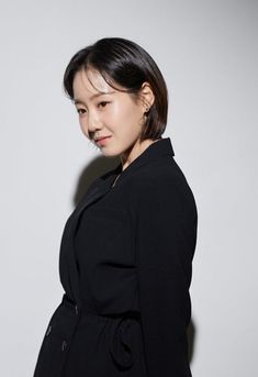 This contains an image of: Min Hee Jin  wearing a black coat 