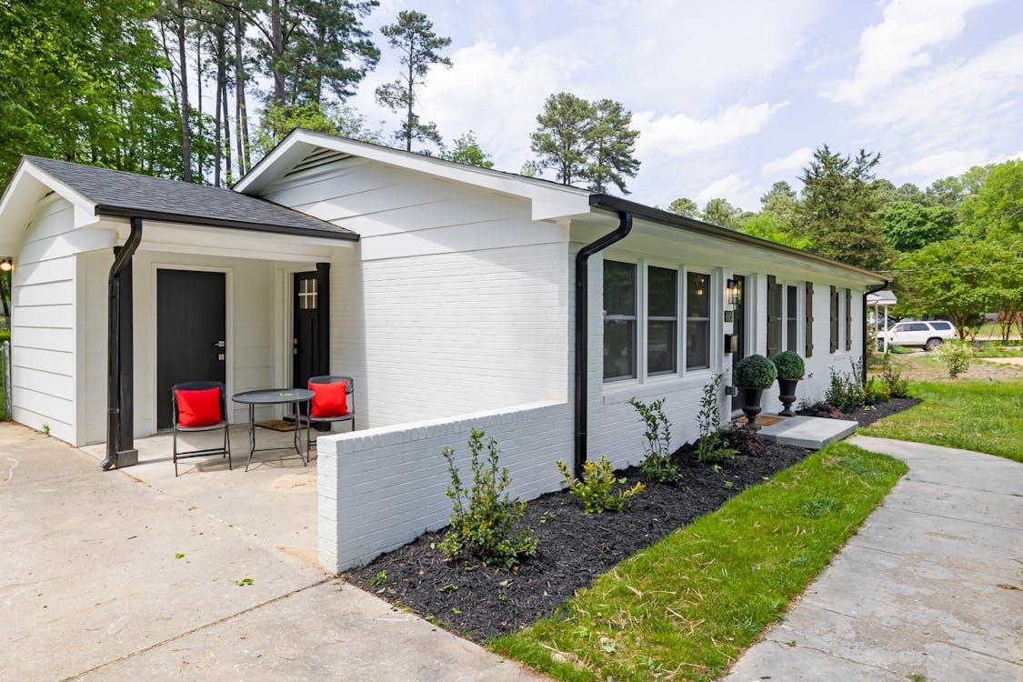 Free White and Gray House Near Green Trees Stock Photo