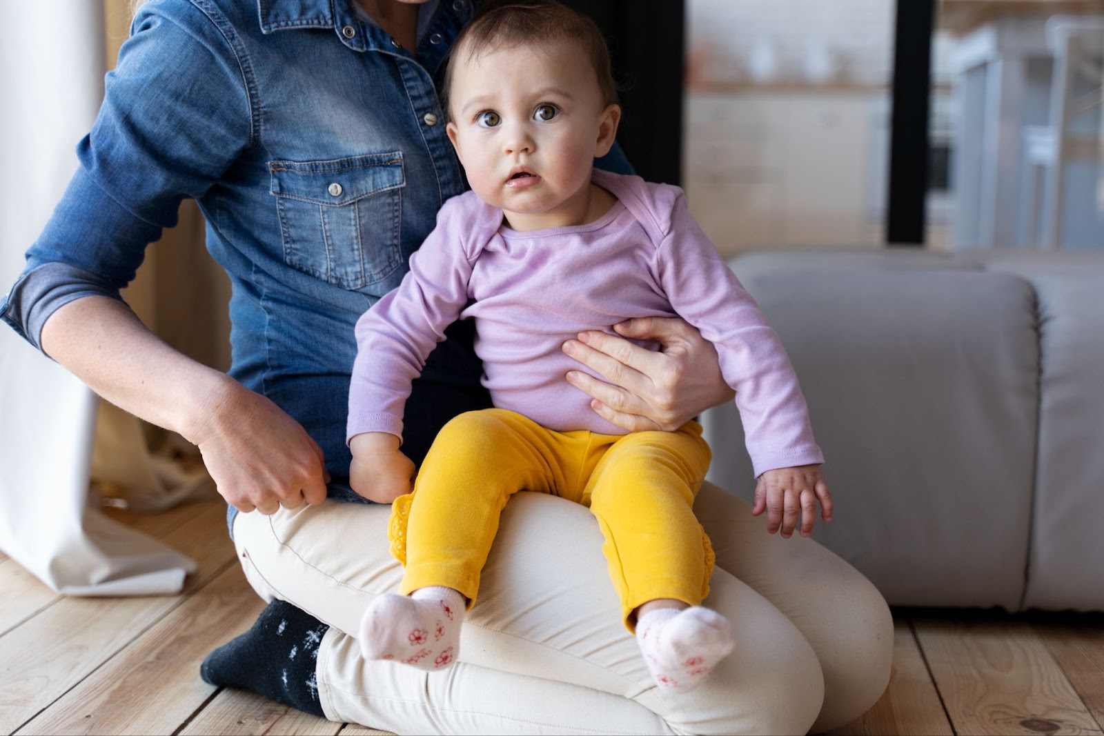 Mother holding her baby on her lap