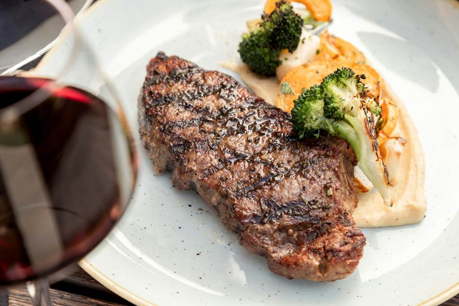 A plate of food with a glass of wine

AI-generated content may be incorrect.