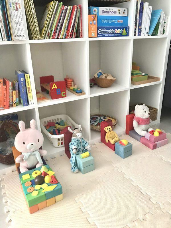 Children have creatively arranged the blocks to resemble a table, as they prepare for a delightful pretend play tea time session with dolls. 