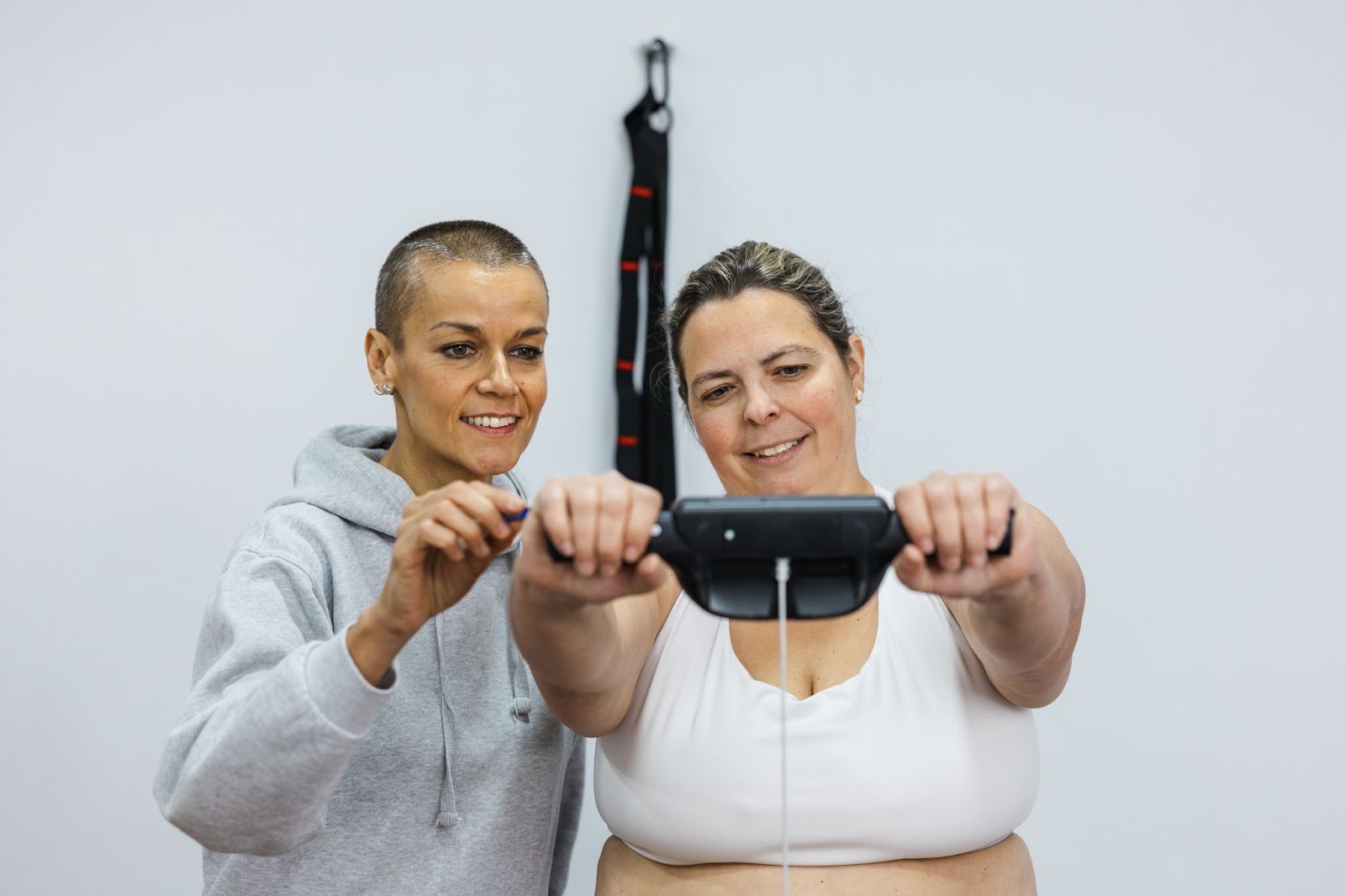 A professional weight loss coach assisting a client with a body composition analysis, symbolizing science-backed fat loss strategies. This image represents personalized weight loss plans, metabolism tracking, and muscle preservation.