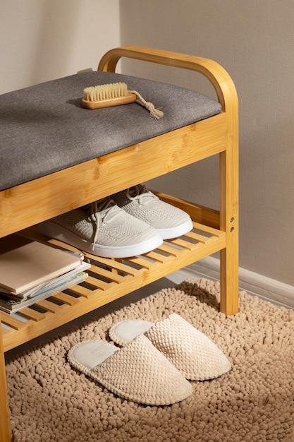 A shoe rack with shoes and a brush
