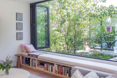 design tips for remodeling your northern michigan vacation rental living room with large window and book bench seating custom built michigan