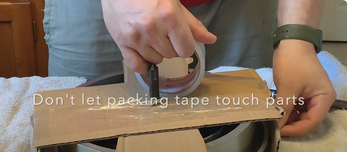 Securing a turntable with cardboard and packing tape