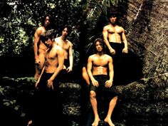 This is a group picture of Shinhwa members all in bare chests and black trousers