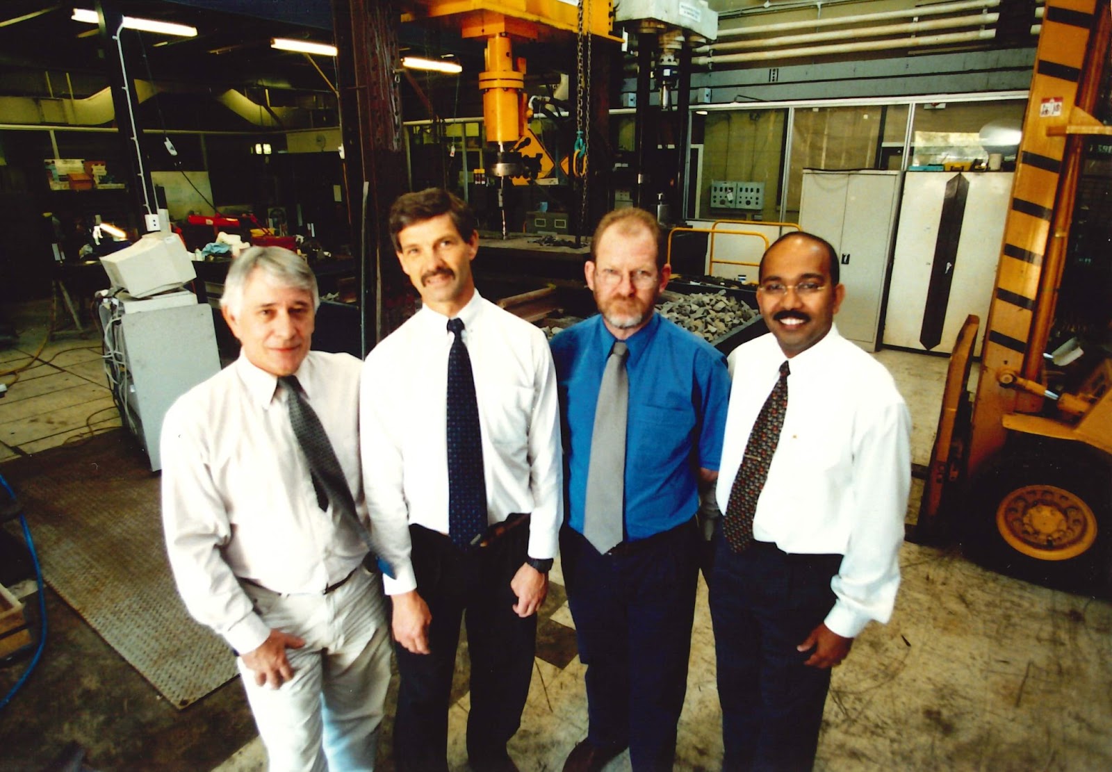 Caption: Monash IRT Leadership Team in 2000, Klaus Epp, Graham Tew, Peter Mutton, and current Director Ravi Ravitharan (Monash IRT Archives).