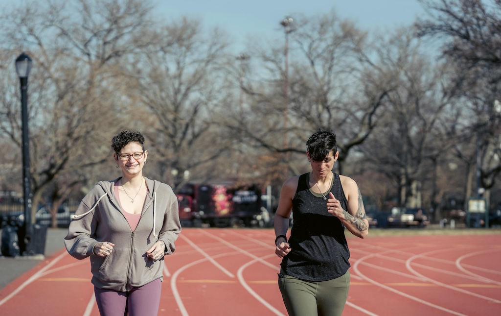 two women running on a track