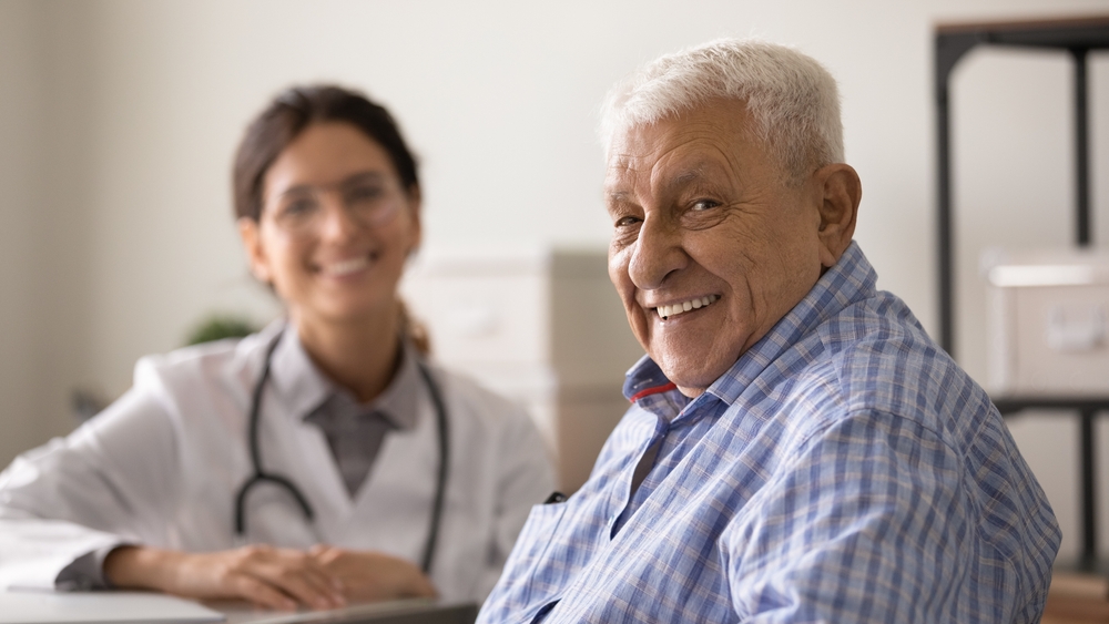 Older man consulting with a doctor, representing personalized care and advanced health strategies offered by longevity clinics to promote longer and healthier lives.