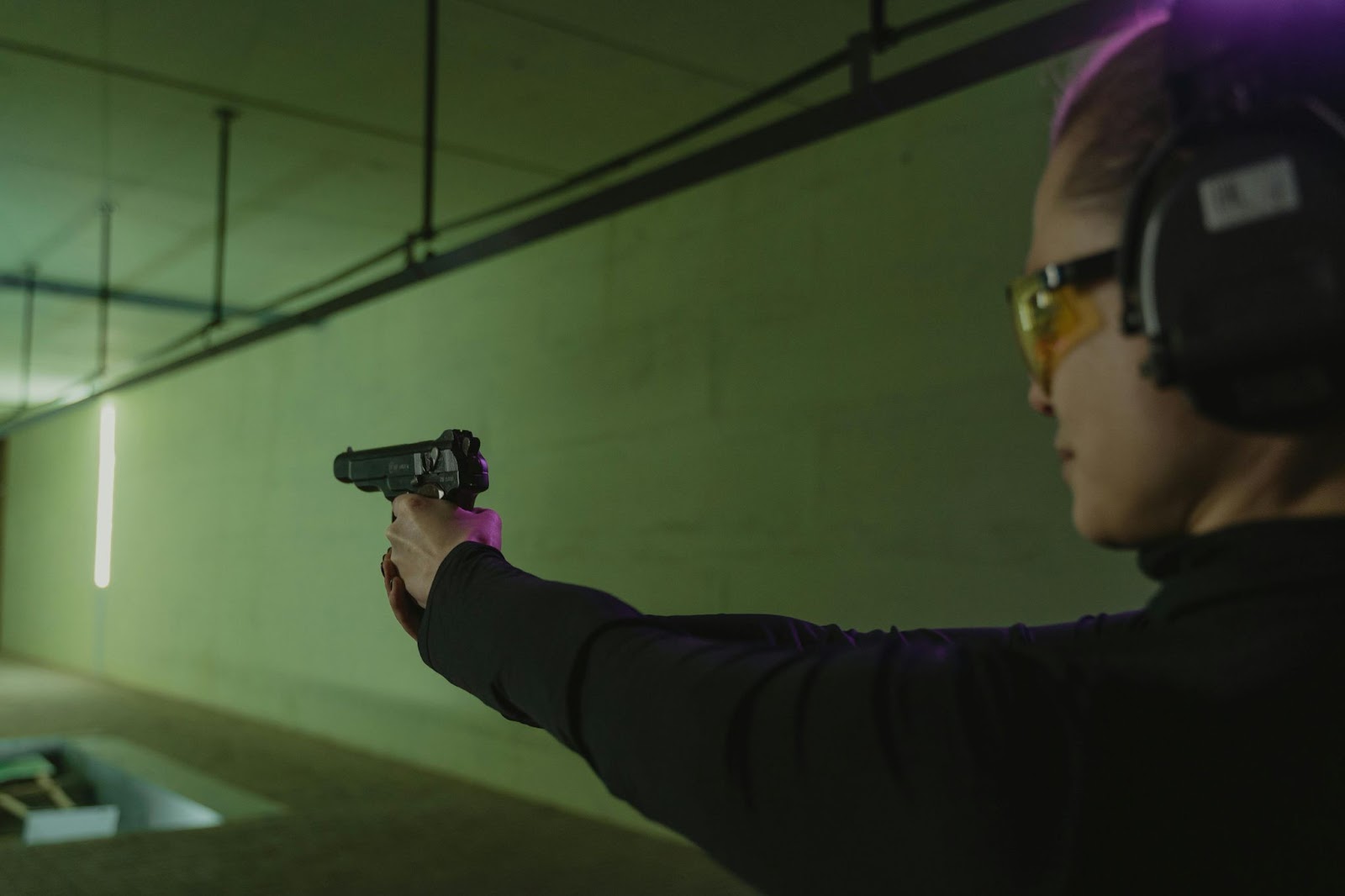 Woman practicing handgun shooting in one of the shooting ranges in Arizona