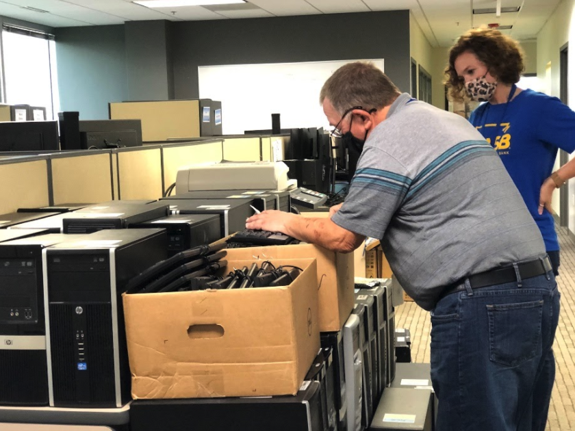 North American Savings Bank employees preparing computers for donation